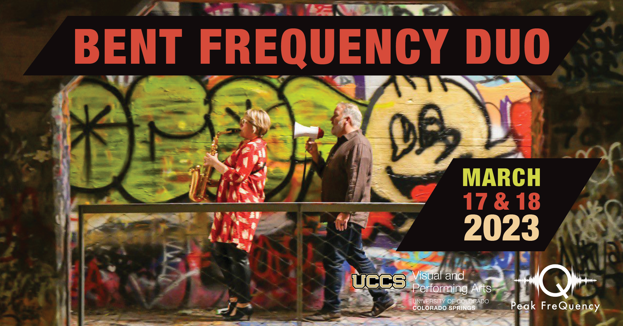 Bent Frequency Duo's Jan Berry Baker with a saxophone and Stuart Gerber with a megaphone walking in front of a wall painted with street art