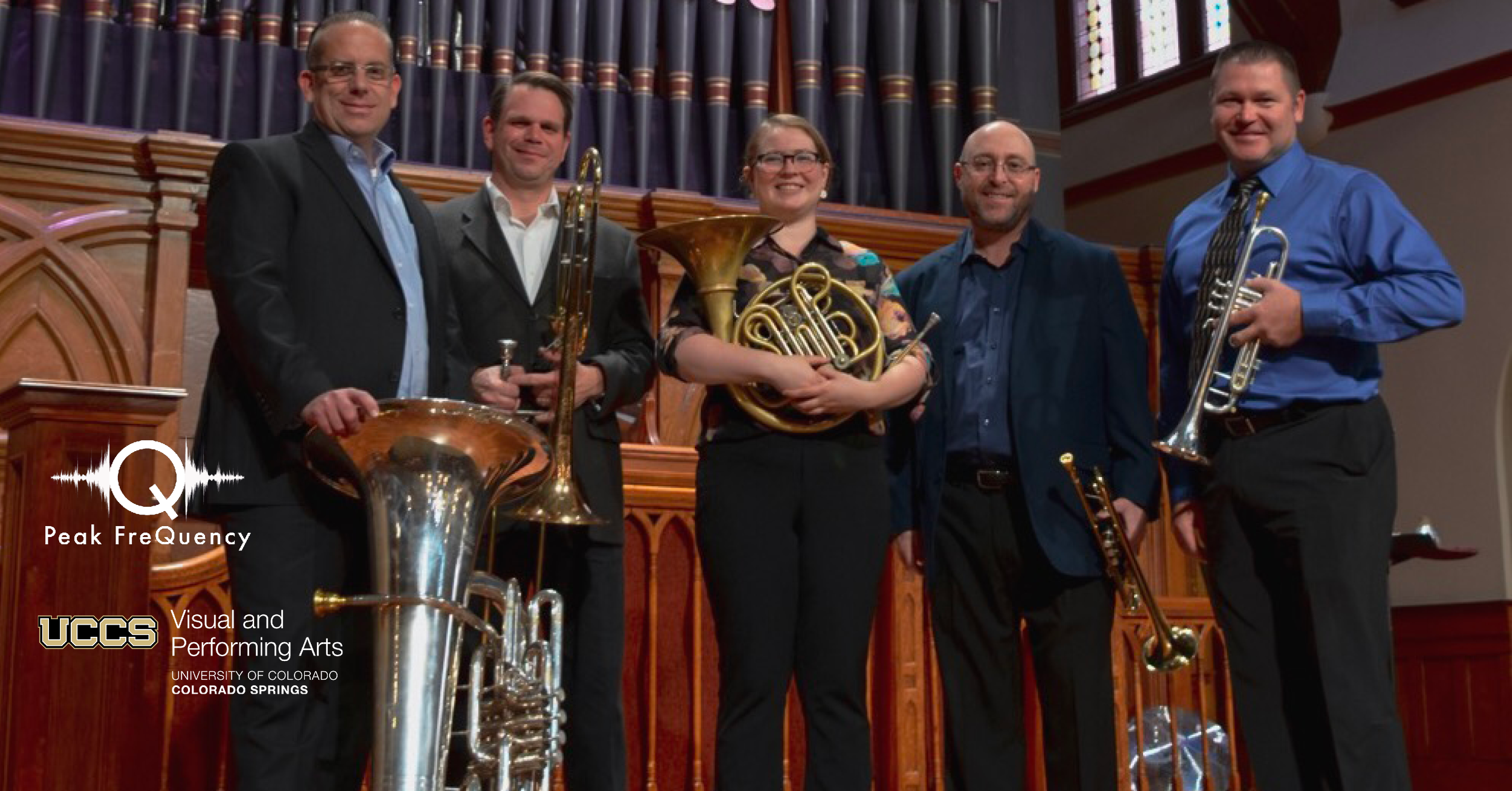 photo of nexus brass holding their instruments in the transept of a church