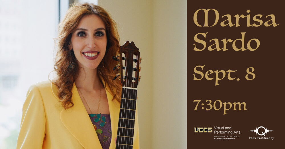 marisa sardo holding the neck of a guitar in front of a bright window