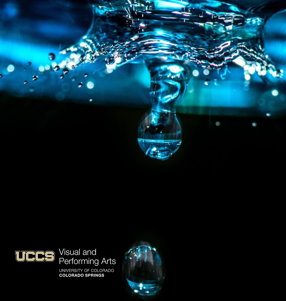 image of blue water droplet hitting water with black background